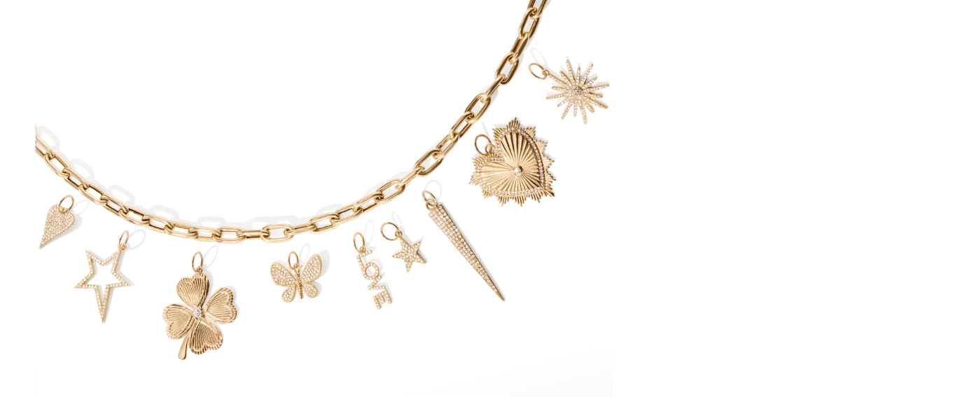 Gold necklace with various charms on a white background
