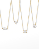 Set of diamond necklaces on thin chains against a white background