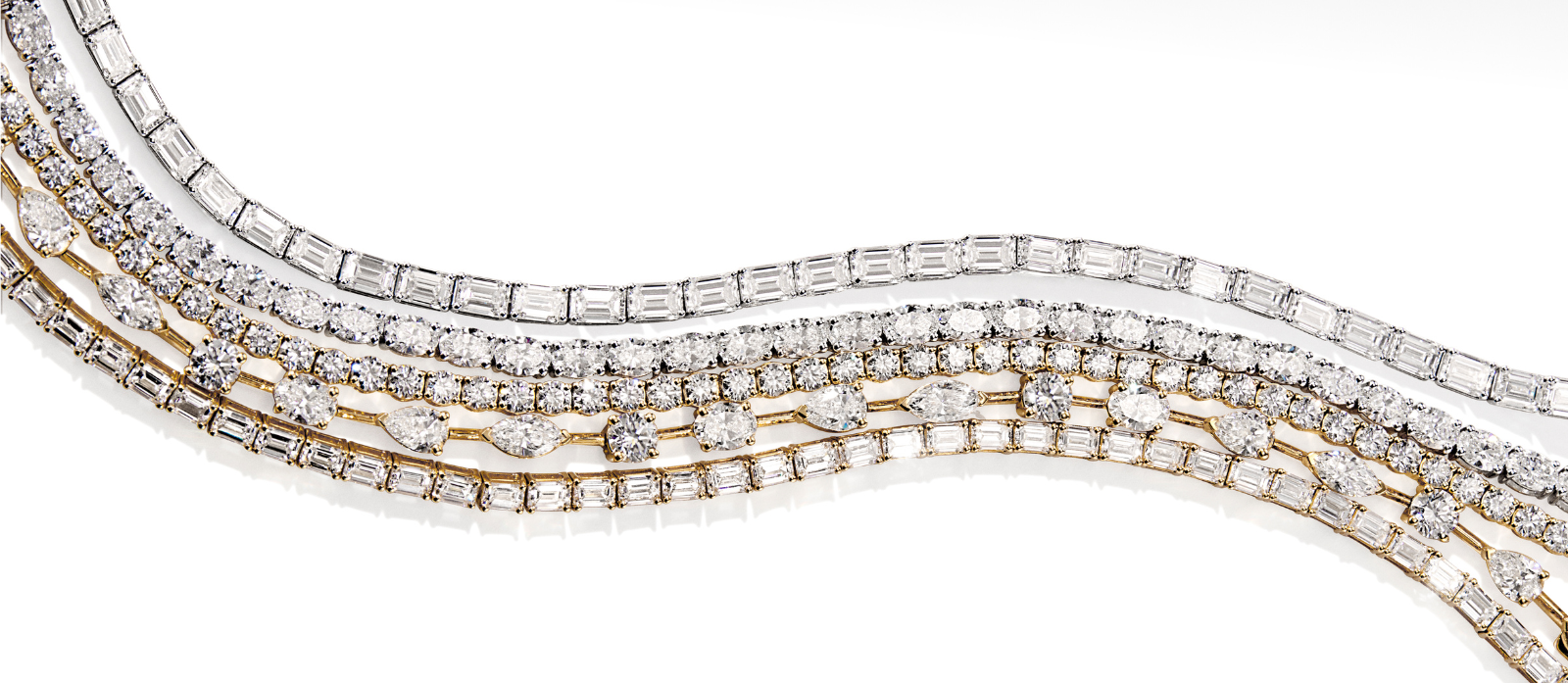 Set of diamond-studded necklaces on a white background